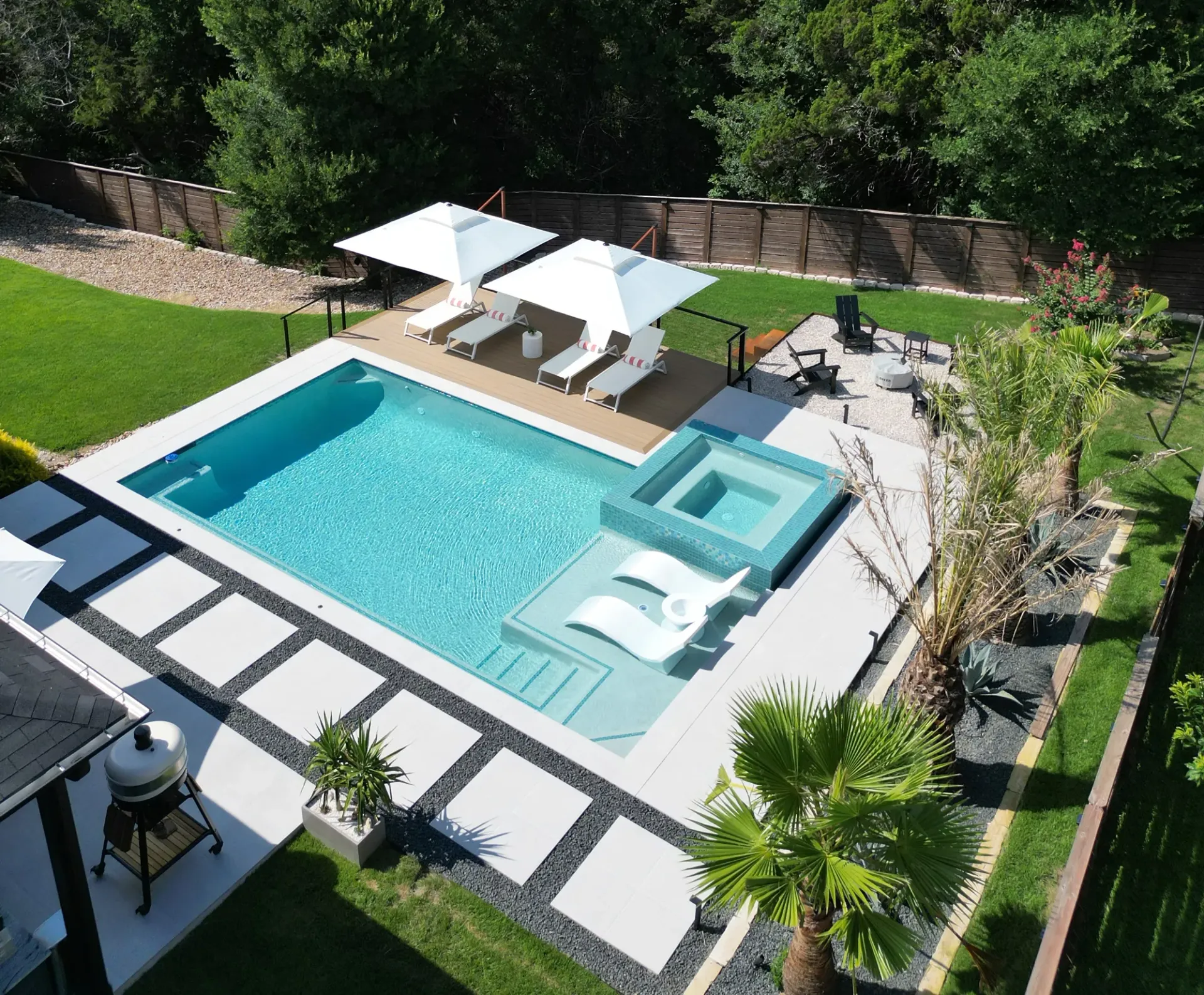 Outdoor living pavilion with pool, kitchen, and pergola in Bee Cave, TX