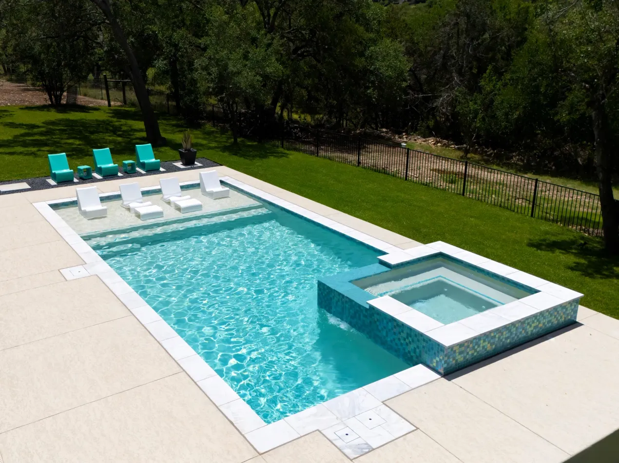 Mediterranean courtyard pool with stucco walls and hand-cut limestone in Bee Cave, TX